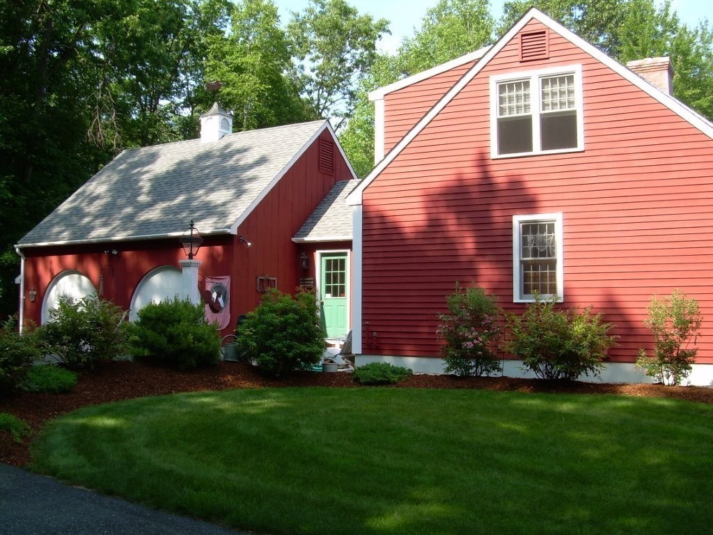 1005 Southbridge Road Warren, MA 01585 - Photo 3 of 30 a view of a house with brick walls and a yard with plants