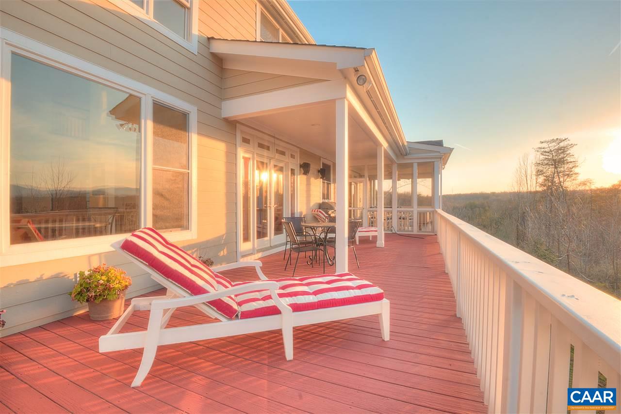 112 Creekside Court Ruckersville, VA 22968 - Photo 13 of 48 a balcony with couch and wooden floor
