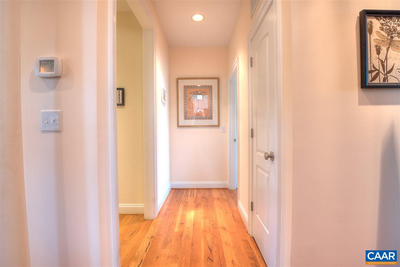 112 Creekside Court Ruckersville, VA 22968 - Photo 16 of 48 a view of a hallway with wooden floor and a bathroom