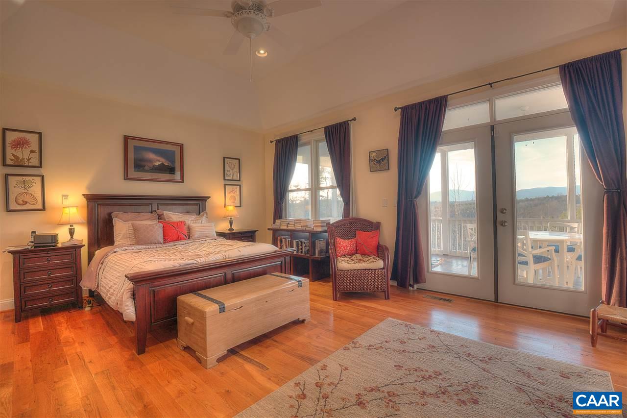 112 Creekside Court Ruckersville, VA 22968 - Photo 17 of 48 a bedroom with a large bed and a large window