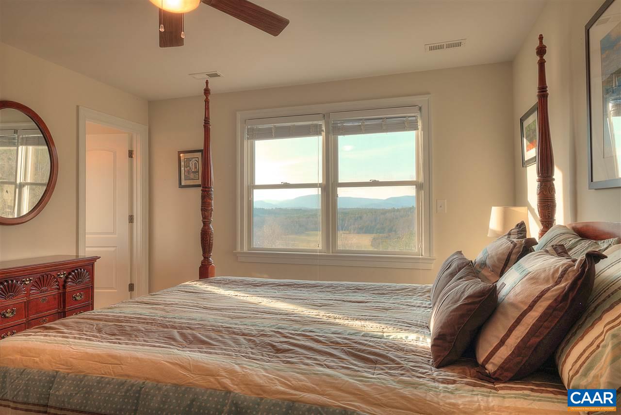 112 Creekside Court Ruckersville, VA 22968 - Photo 29 of 48 a bed sitting in a bedroom next to a window