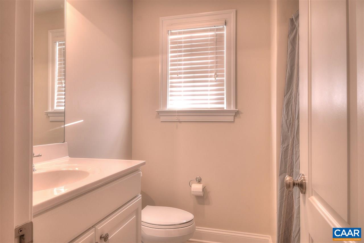 112 Creekside Court Ruckersville, VA 22968 - Photo 34 of 48 a bathroom with a granite countertop toilet a sink and a bathtub