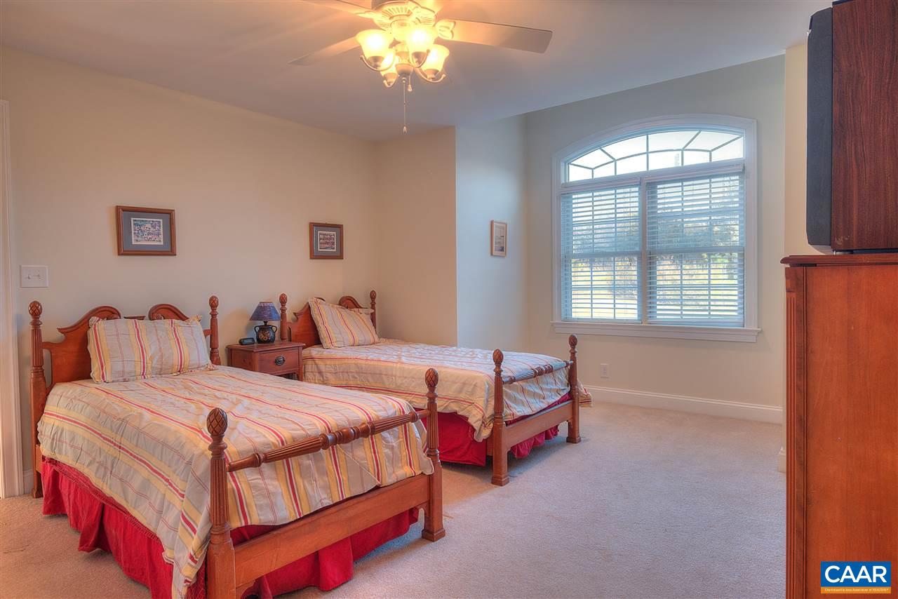 112 Creekside Court Ruckersville, VA 22968 - Photo 36 of 48 a bedroom with two beds and a chandelier