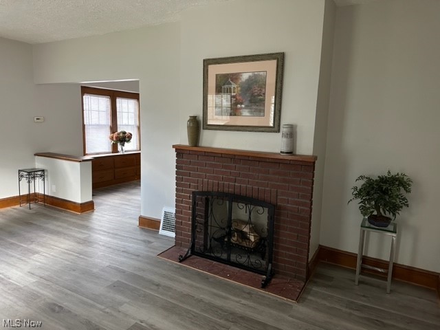 997 Berwin Street Akron, OH 44310 - Photo 6 of 34 Hardwood floored living room with a fireplace and a textured ceiling
