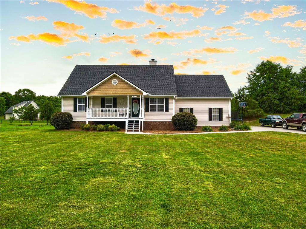473 Harris Beamer Road Southwest Calhoun, GA 30701 - Photo 1 of 1 a front view of a house with a yard table and chairs