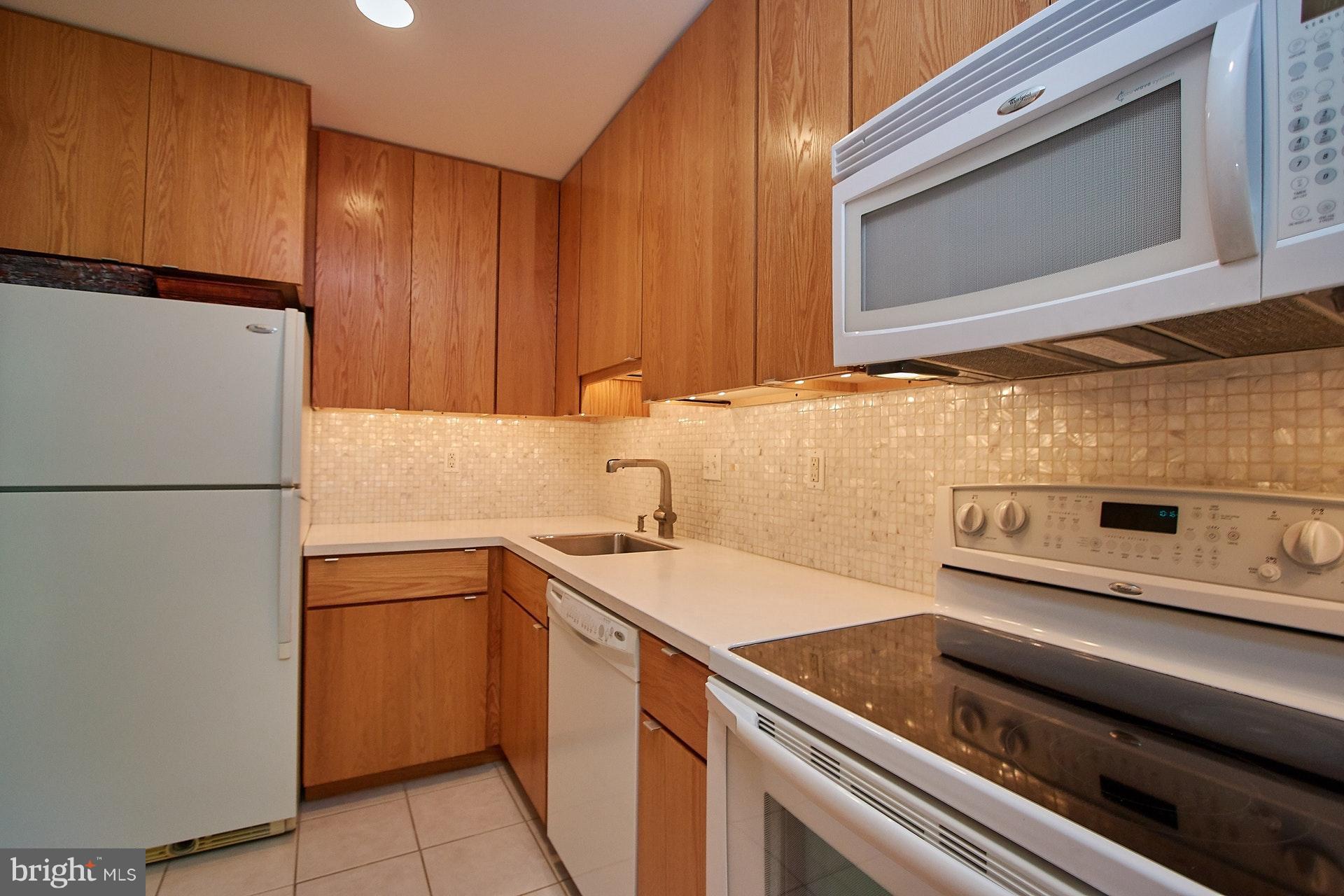 11444 Orchard Lane Reston, VA 20190 - Photo 6 of 30 a kitchen with a sink and a refrigerator