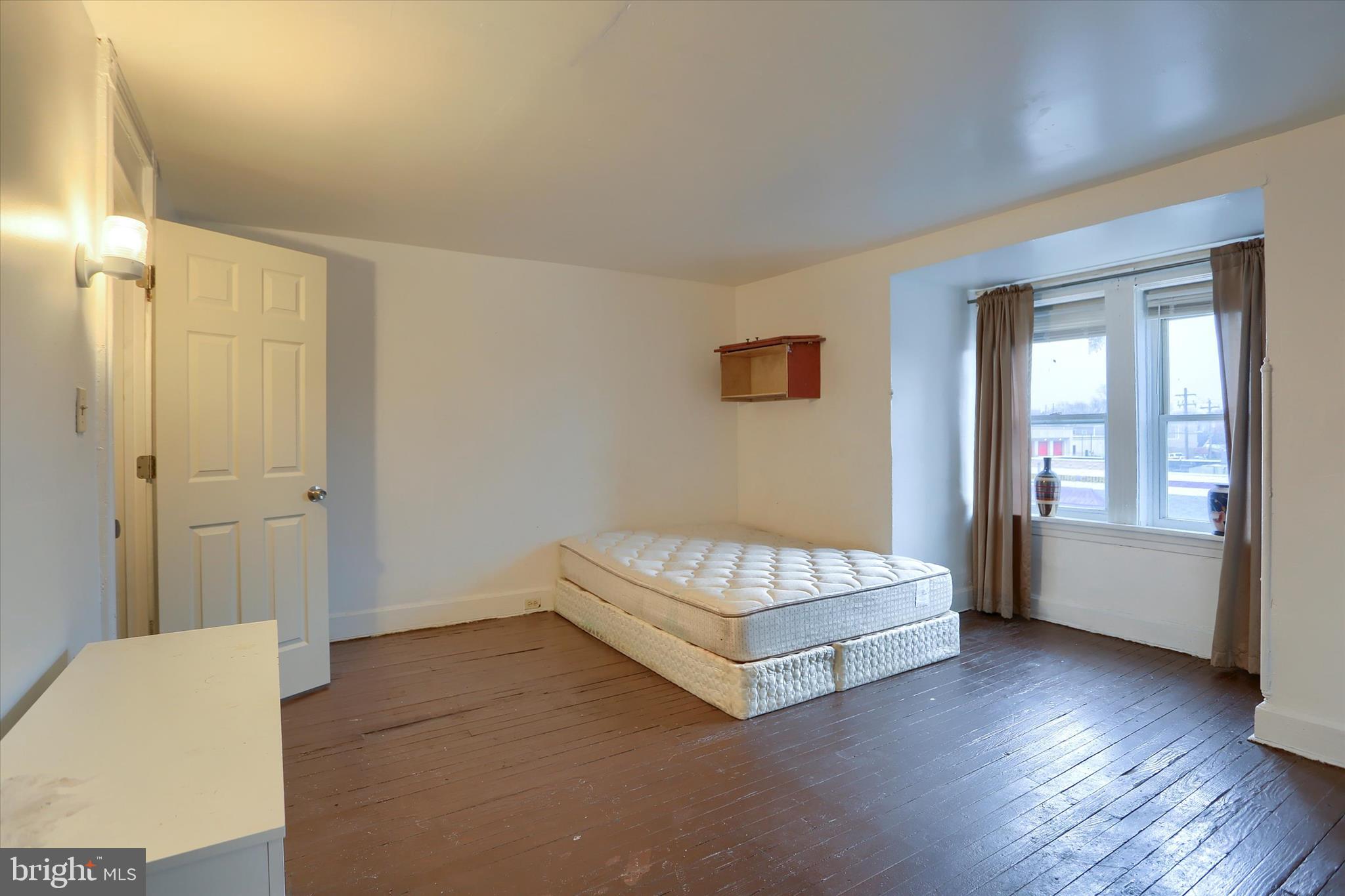 1420 State Street Harrisburg, PA 17103 - Photo 14 of 16 a spacious bedroom with a bed and a couch