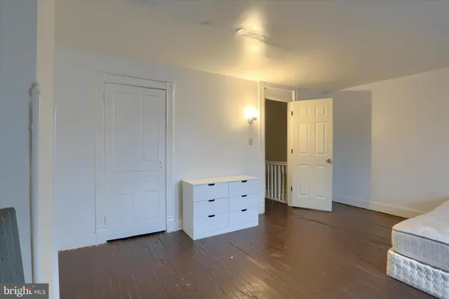 an empty room with a wooden cabinet