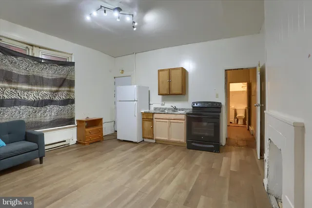 a kitchen with a refrigerator and a sink