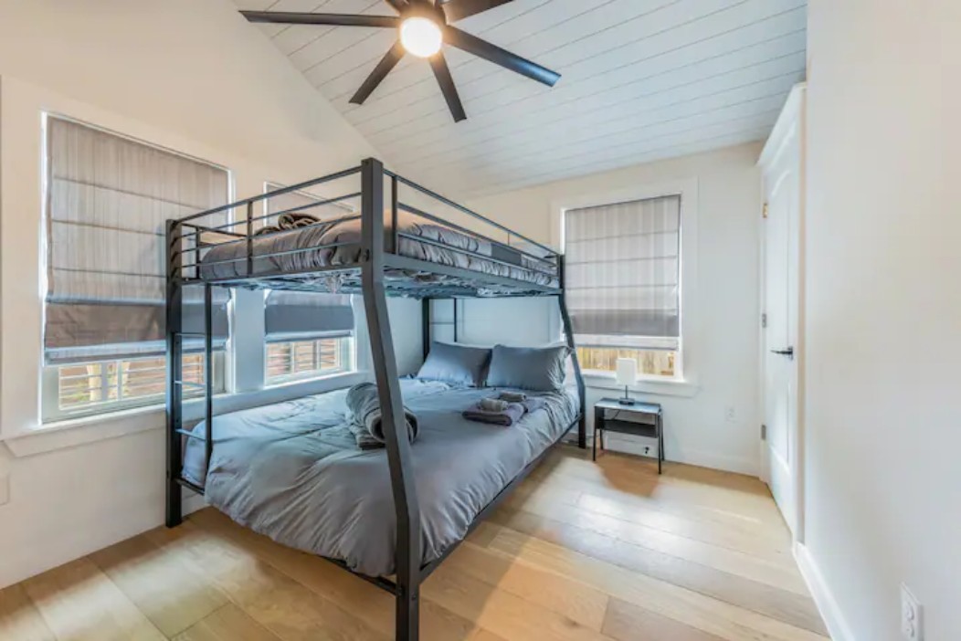 2319 Santa Rita Street Austin, TX 78702 - Photo 18 of 26 Bedroom with light wood finished floors, a ceiling fan, and vaulted ceiling