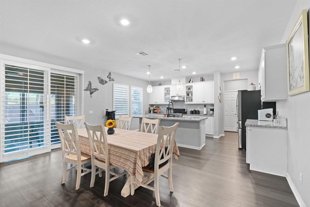 33009 Marin Fields Road Winchester, CA 92596 - Photo 13 of 51 a view of a dining room with furniture and wooden floor
