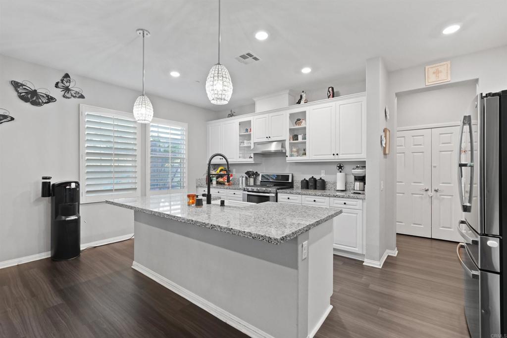 33009 Marin Fields Road Winchester, CA 92596 - Photo 14 of 51 a kitchen with stainless steel appliances granite countertop a sink a stove and refrigerator
