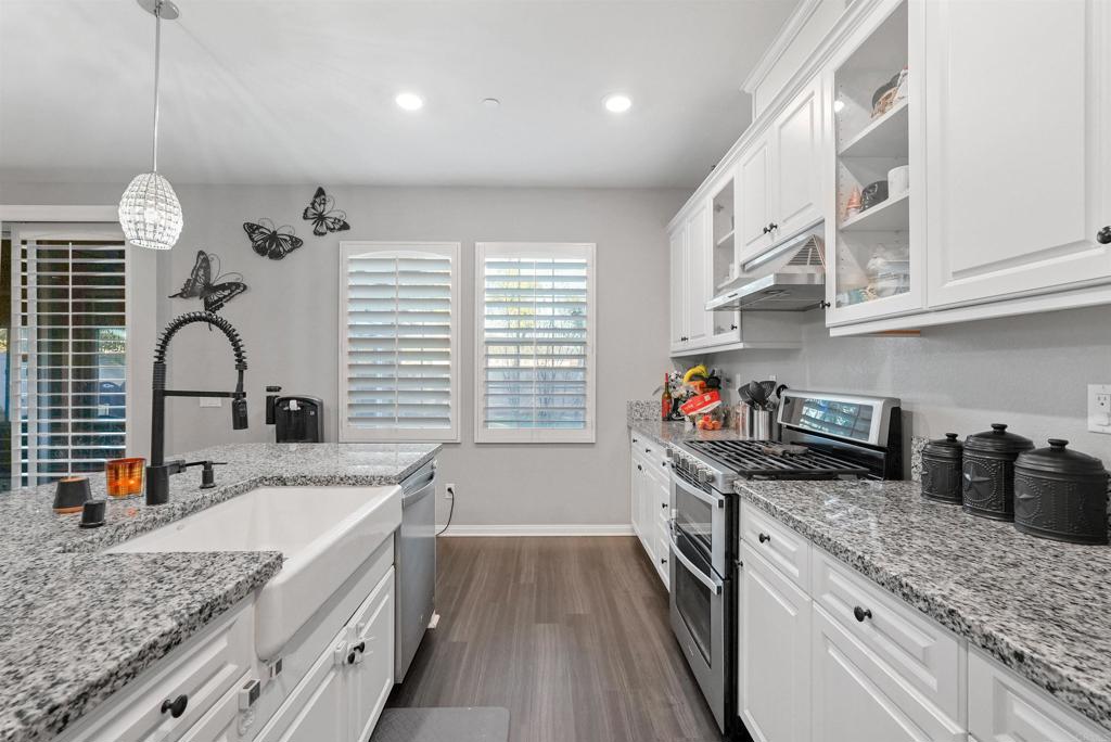 33009 Marin Fields Road Winchester, CA 92596 - Photo 15 of 51 a kitchen with granite countertop a sink a counter space appliances and cabinets