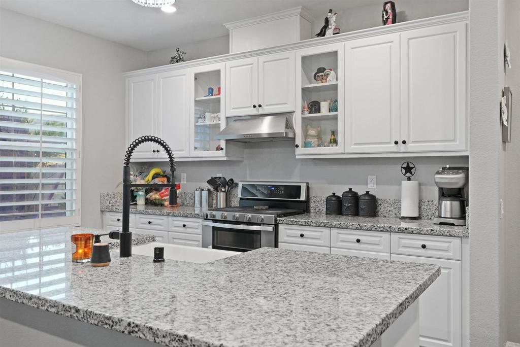 33009 Marin Fields Road Winchester, CA 92596 - Photo 18 of 51 a kitchen with stainless steel appliances granite countertop a sink stove and cabinets