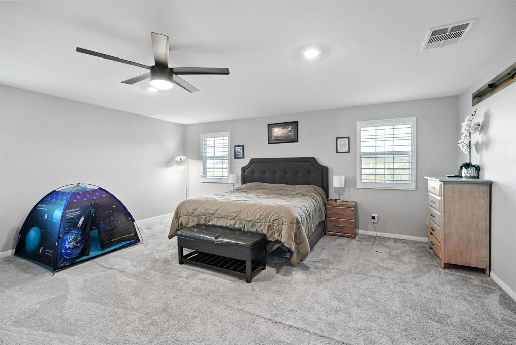 33009 Marin Fields Road Winchester, CA 92596 - Photo 23 of 51 a bedroom with a bed and a chair