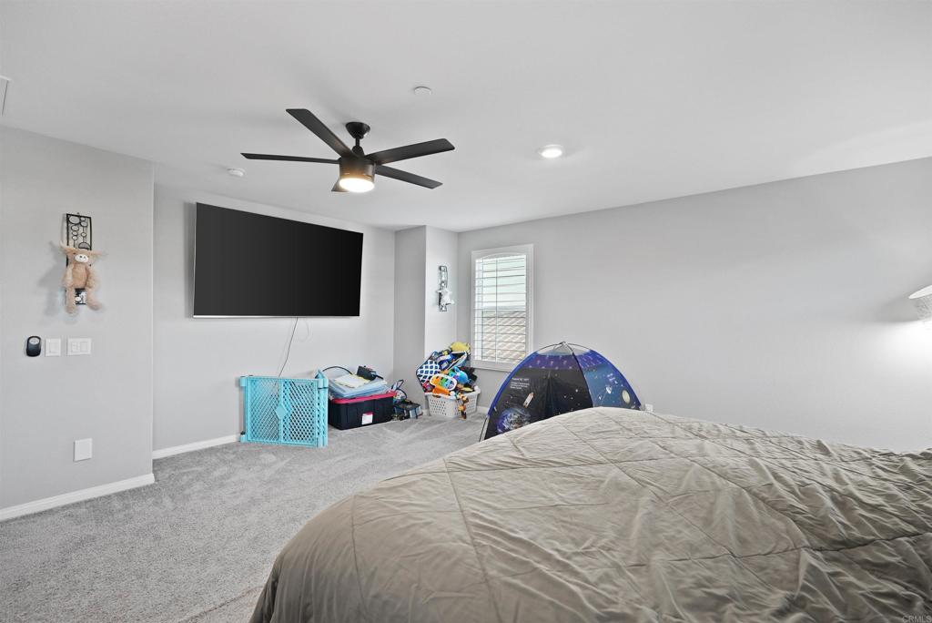 33009 Marin Fields Road Winchester, CA 92596 - Photo 25 of 51 a bedroom with a bed and a flat screen tv