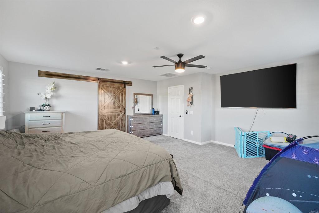 33009 Marin Fields Road Winchester, CA 92596 - Photo 26 of 51 a bedroom with a bed and a flat screen tv