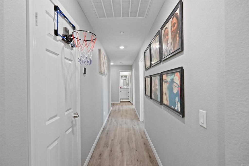 33009 Marin Fields Road Winchester, CA 92596 - Photo 31 of 51 a view of a hallway with wooden floor and staircase
