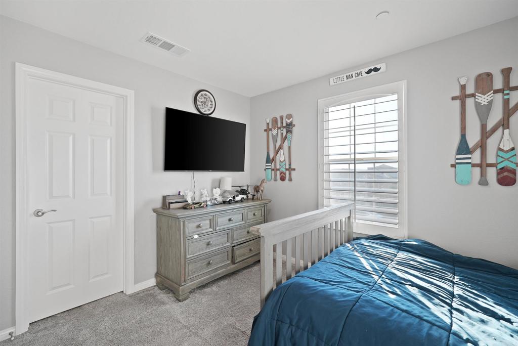 33009 Marin Fields Road Winchester, CA 92596 - Photo 33 of 51 a bedroom with a bed and a flat screen tv