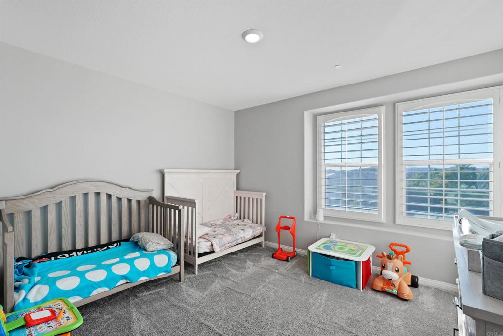 33009 Marin Fields Road Winchester, CA 92596 - Photo 34 of 51 a bedroom with baby crib and a window