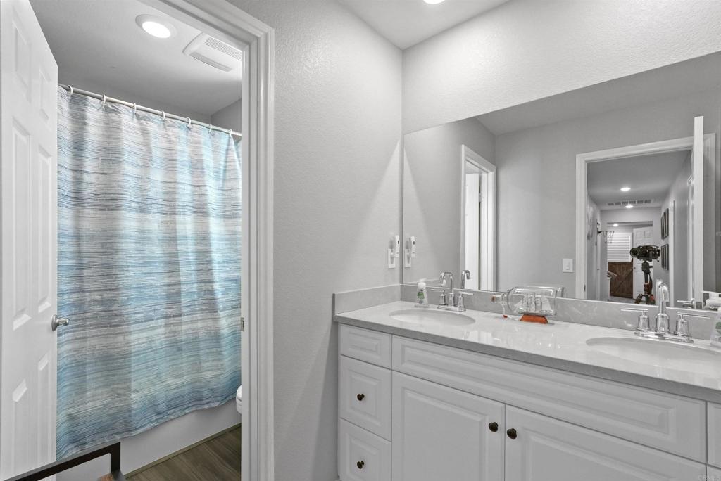 33009 Marin Fields Road Winchester, CA 92596 - Photo 36 of 51 a bathroom with a double vanity sink mirror and shower