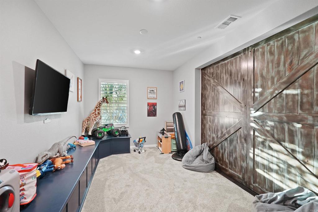 33009 Marin Fields Road Winchester, CA 92596 - Photo 6 of 51 a bedroom with furniture and a flat screen tv