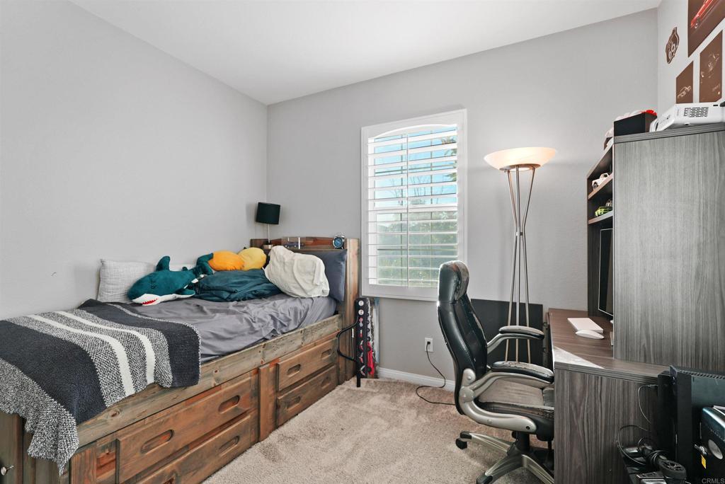 33009 Marin Fields Road Winchester, CA 92596 - Photo 7 of 51 a bedroom with a bed and a chair