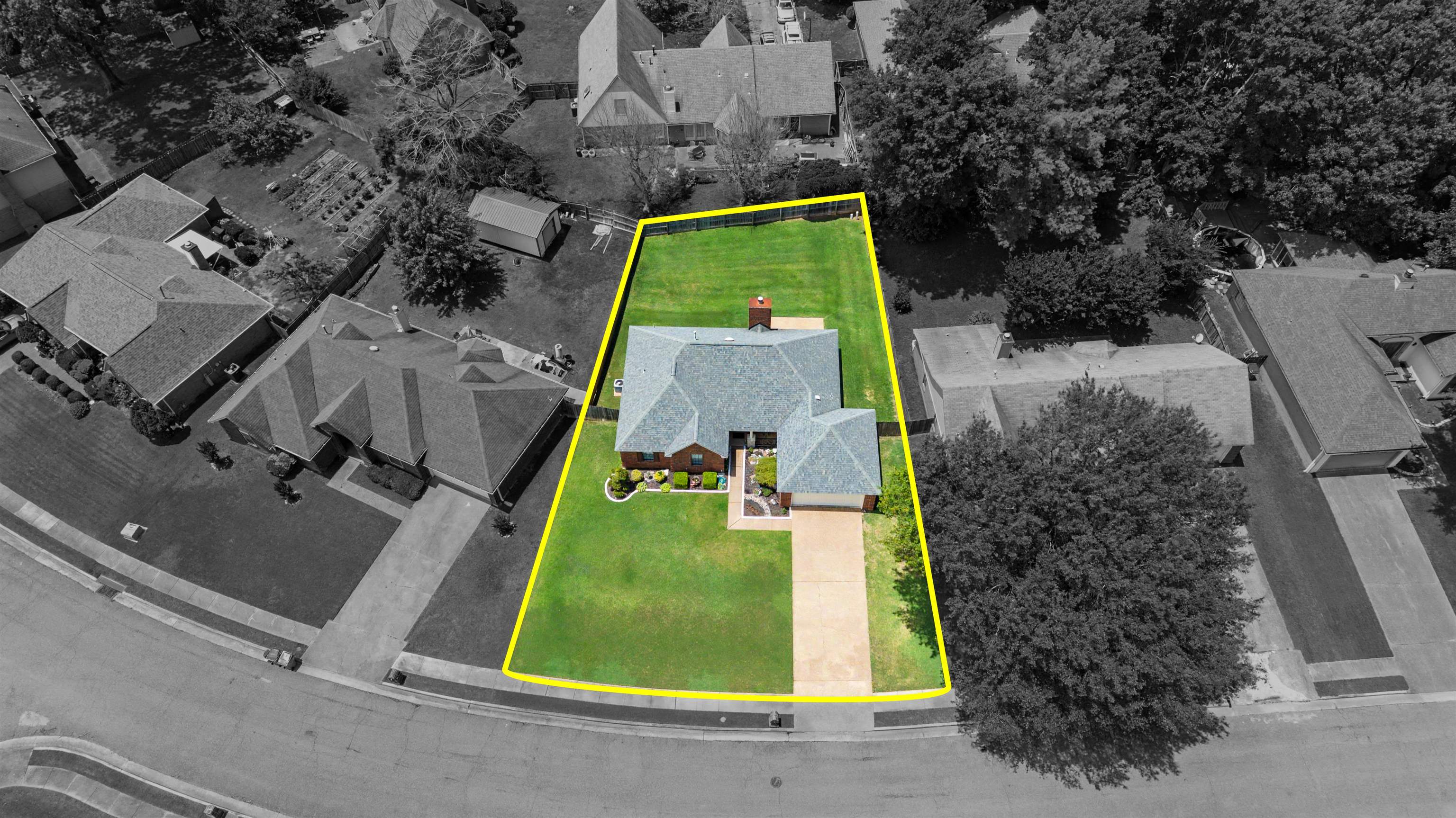 5127 Overview Ridge Memphis, TN 38141 - Photo 32 of 36 Expansive green lawn surrounds a single-story residence with a light-colored shingle roof