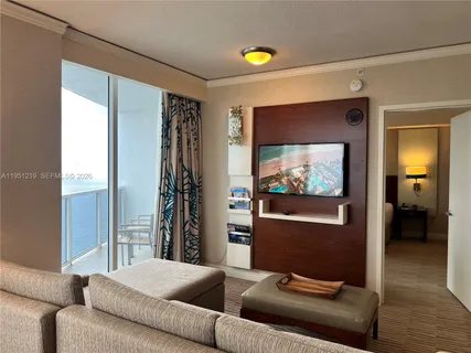 a living room with furniture and a flat screen tv