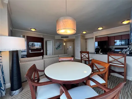 a dining room with furniture and a chandelier