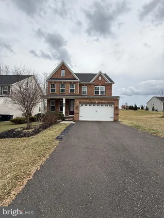 a view of a house with a big yard and large tree