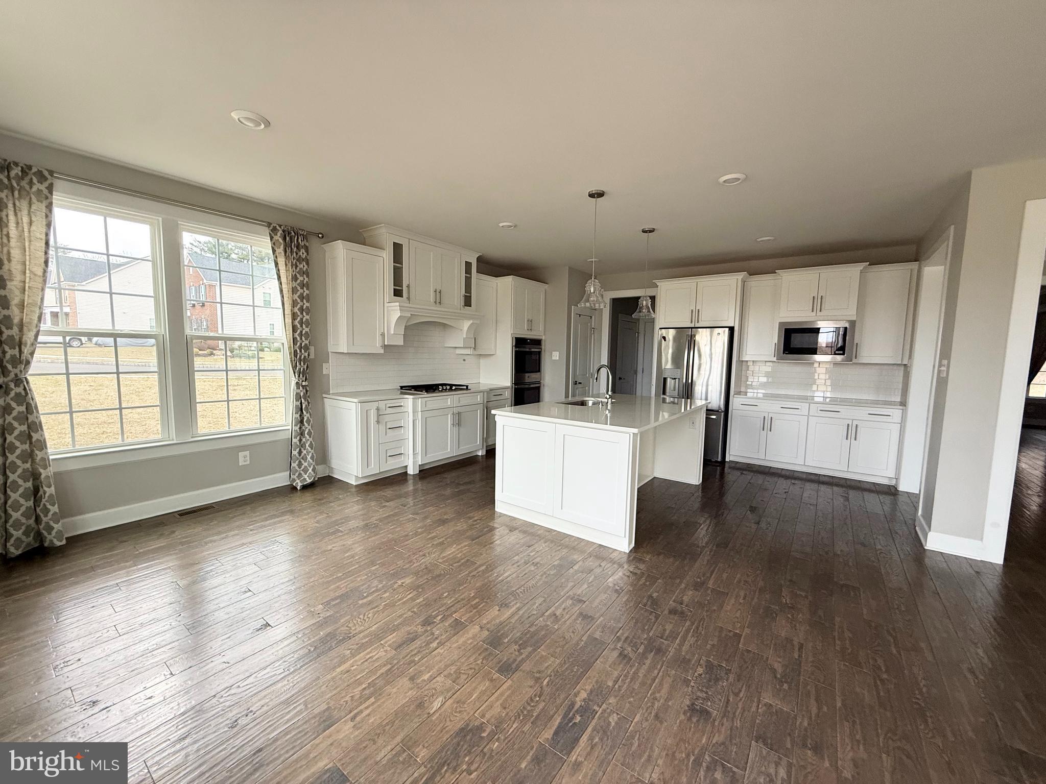 2575 Bailey Circle Philadelphia, PA 19115 - Photo 8 of 36 a living room with stainless steel appliances kitchen island wooden floors and white cabinets