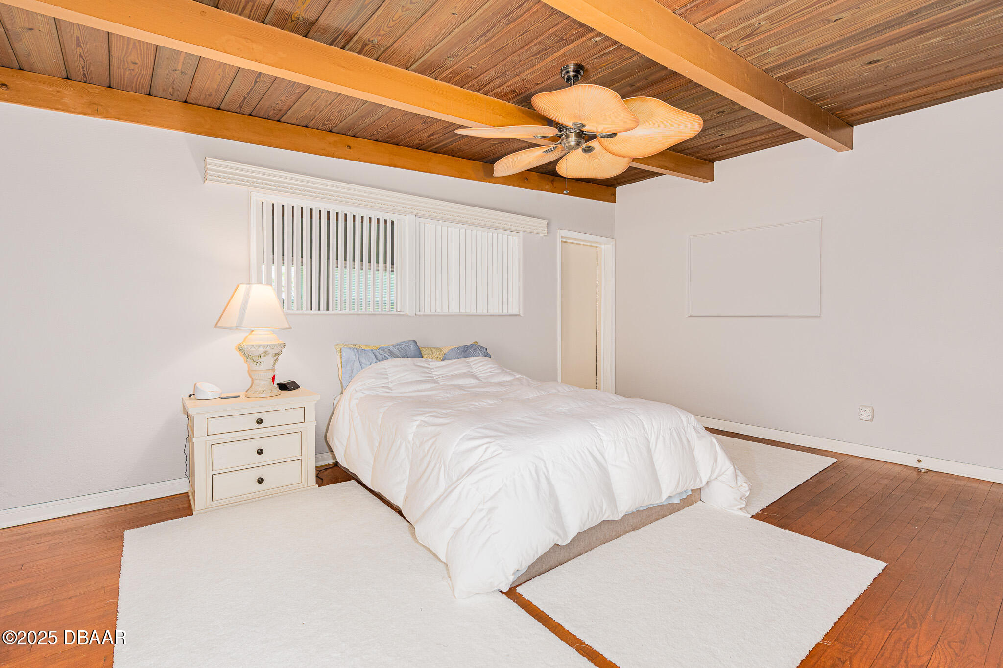 46 Oceanview Avenue Ponce Inlet, FL 32127 - Photo 26 of 79 a bedroom with a bed and a chandelier
