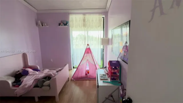 a view of a room with furniture and a window