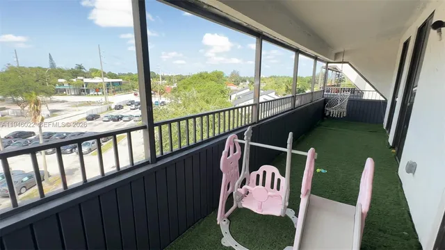 a view of living room with a flat screen tv and a fireplace