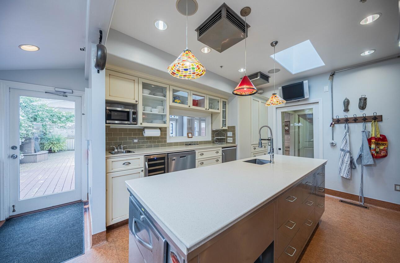 157 15th Street Pacific Grove, CA 93950 - Photo 17 of 41 a kitchen with stainless steel appliances granite countertop a sink dishwasher and a refrigerator with wooden floor