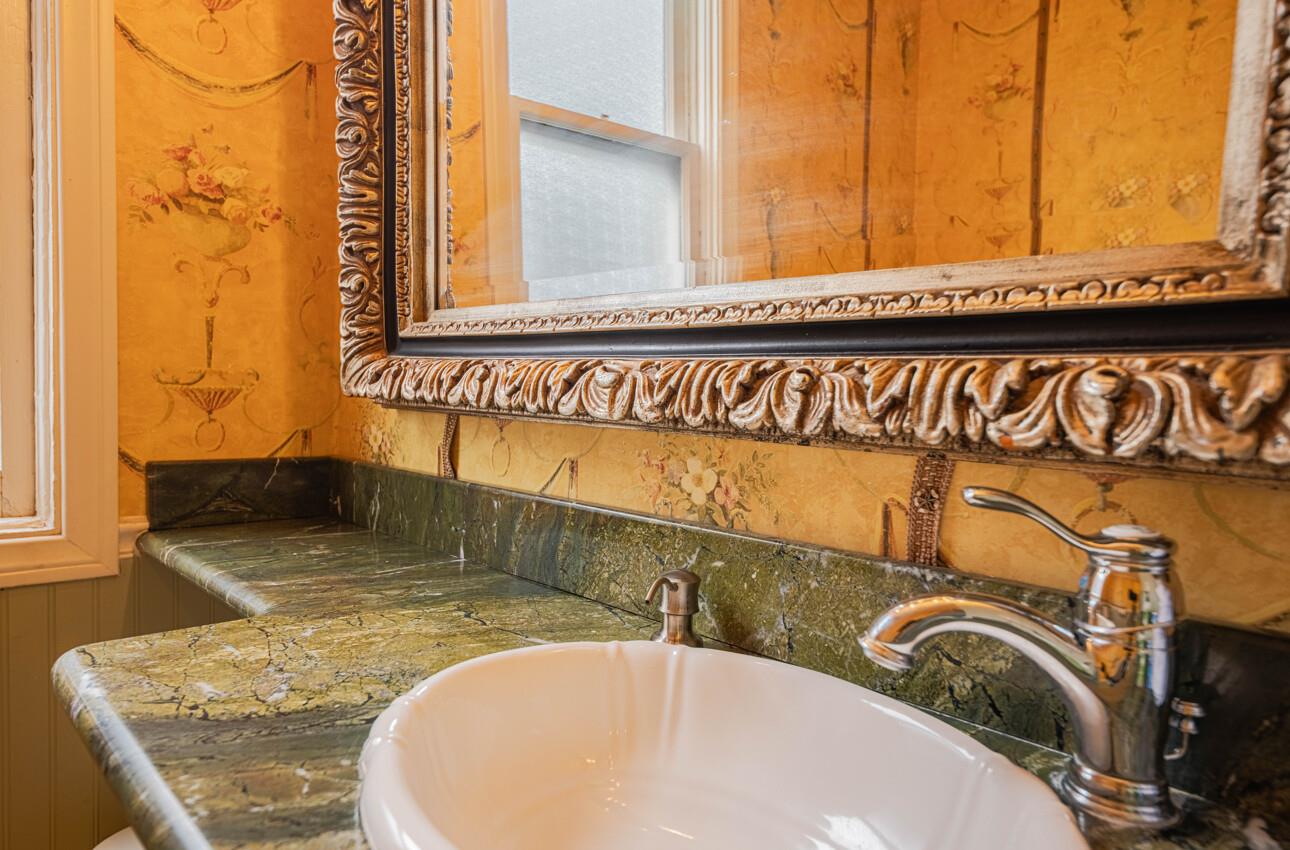 157 15th Street Pacific Grove, CA 93950 - Photo 25 of 41 a bathroom with a granite countertop sink and a mirror