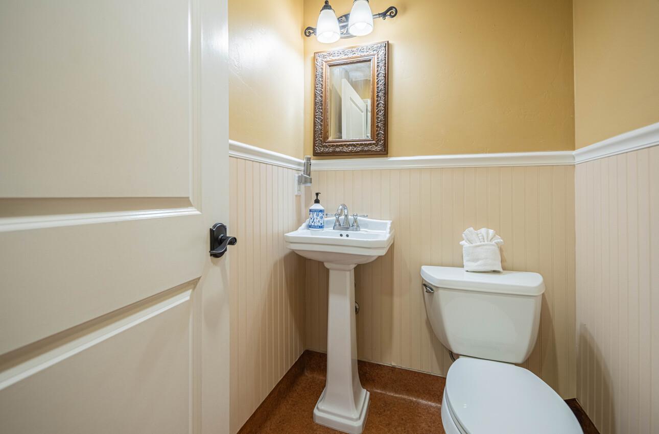 157 15th Street Pacific Grove, CA 93950 - Photo 26 of 41 a bathroom with a toilet sink and mirror