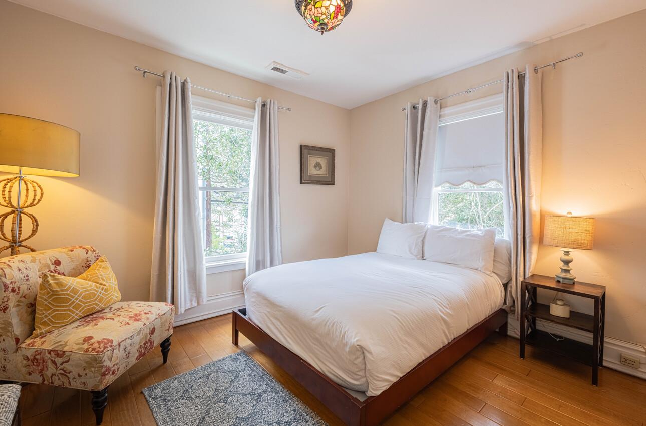157 15th Street Pacific Grove, CA 93950 - Photo 29 of 41 a bedroom with a bed and wooden floor