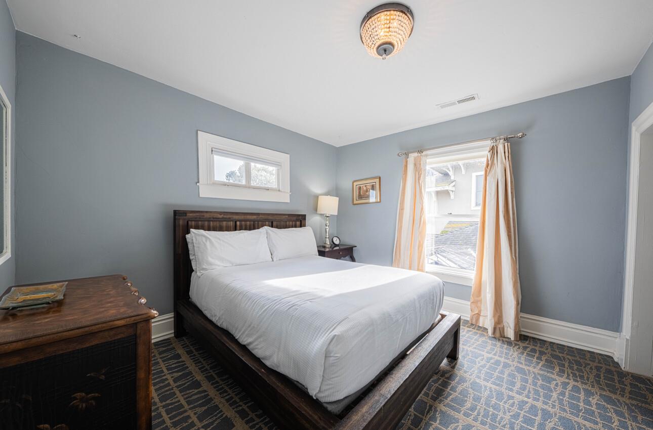 157 15th Street Pacific Grove, CA 93950 - Photo 33 of 41 a bedroom with a bed and a window