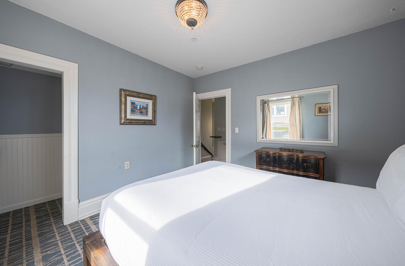 157 15th Street Pacific Grove, CA 93950 - Photo 34 of 41 a bedroom with a bed and a couch