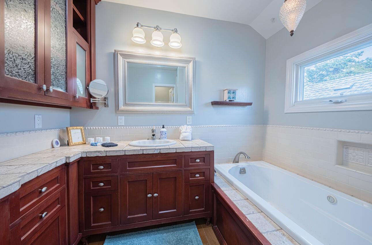 157 15th Street Pacific Grove, CA 93950 - Photo 37 of 41 a spacious bathroom with a granite countertop tub double vanity sink and a window