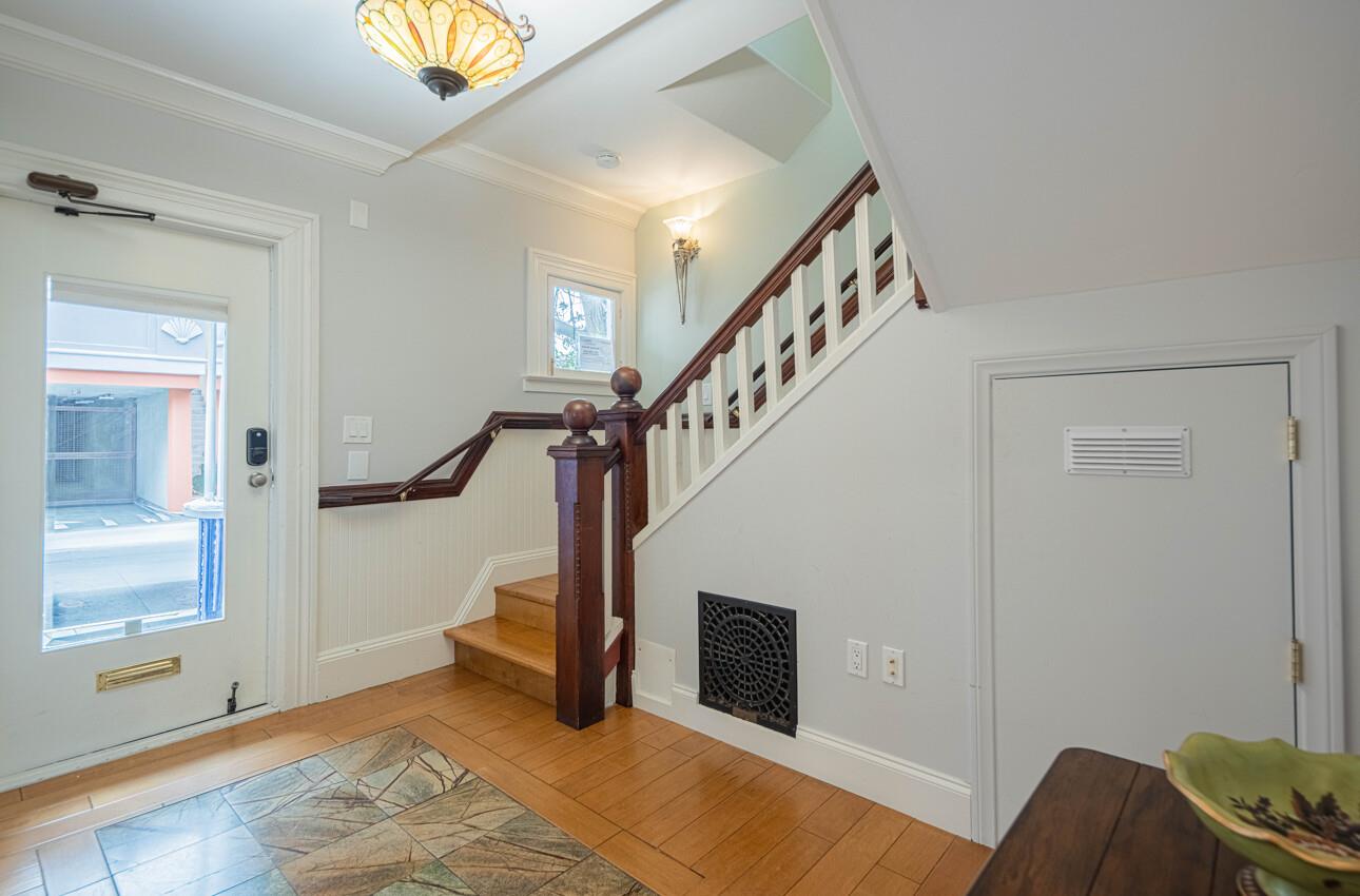 157 15th Street Pacific Grove, CA 93950 - Photo 7 of 41 a view of entryway with wooden floor and stairs