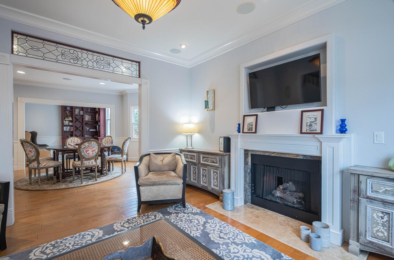 157 15th Street Pacific Grove, CA 93950 - Photo 9 of 41 a living room with furniture a flat screen tv and a fireplace