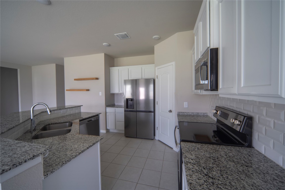 2208 Chia Court Temple, TX 76501 - Photo 2 of 16 a kitchen with stainless steel appliances granite countertop a sink stove and refrigerator