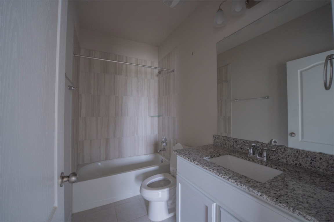 2208 Chia Court Temple, TX 76501 - Photo 8 of 16 a bathroom with a granite countertop sink toilet and shower