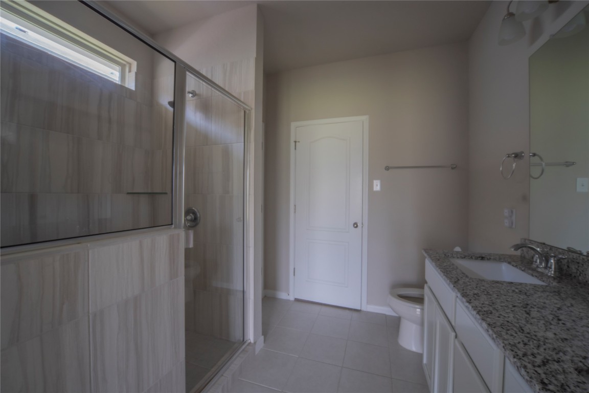 2208 Chia Court Temple, TX 76501 - Photo 9 of 16 a bathroom with a granite countertop sink and shower