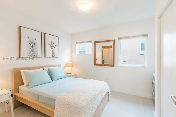 a bedroom with a bed and wall painting