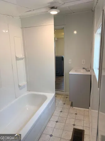 a bathroom with a bathtub and a sink