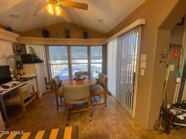 a dining room with furniture and a floor to ceiling window
